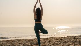 Solo Traveler practicing Yoga at An Bang Beach Hoi An
